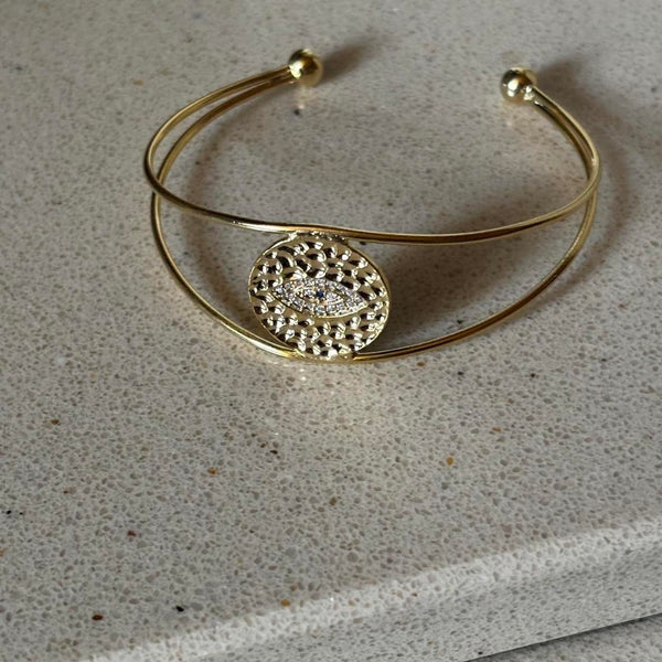 evil eye hammered bangle in gold