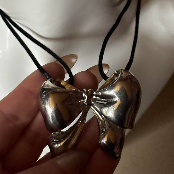 oversized silver ribbon bow necklace