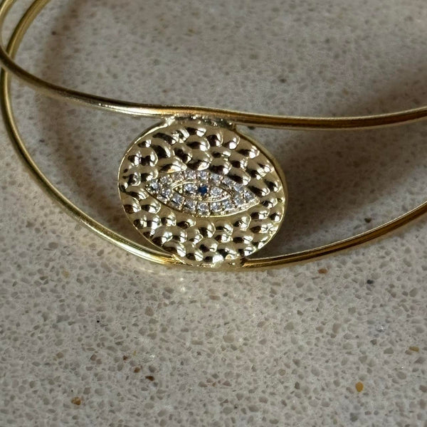 evil eye hammered bangle in gold