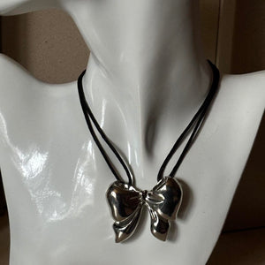 oversized silver ribbon bow necklace