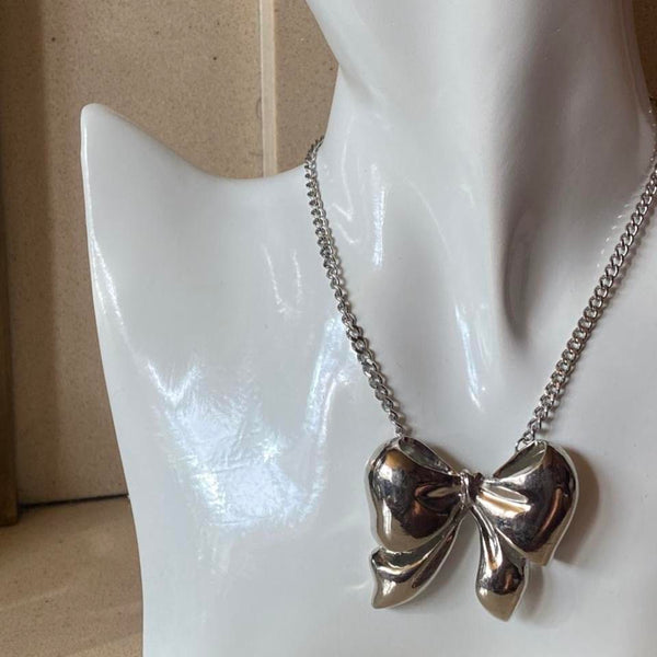 oversized silver ribbon bow necklace